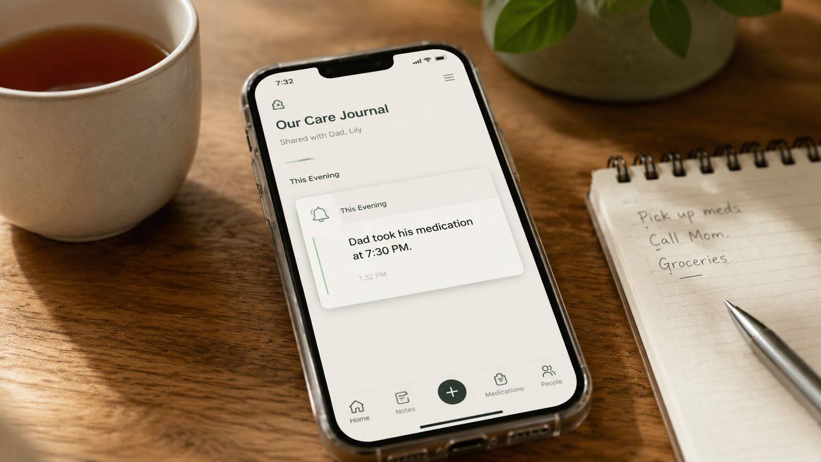 A smartphone displaying a shared daily care journal application placed on a wooden table.