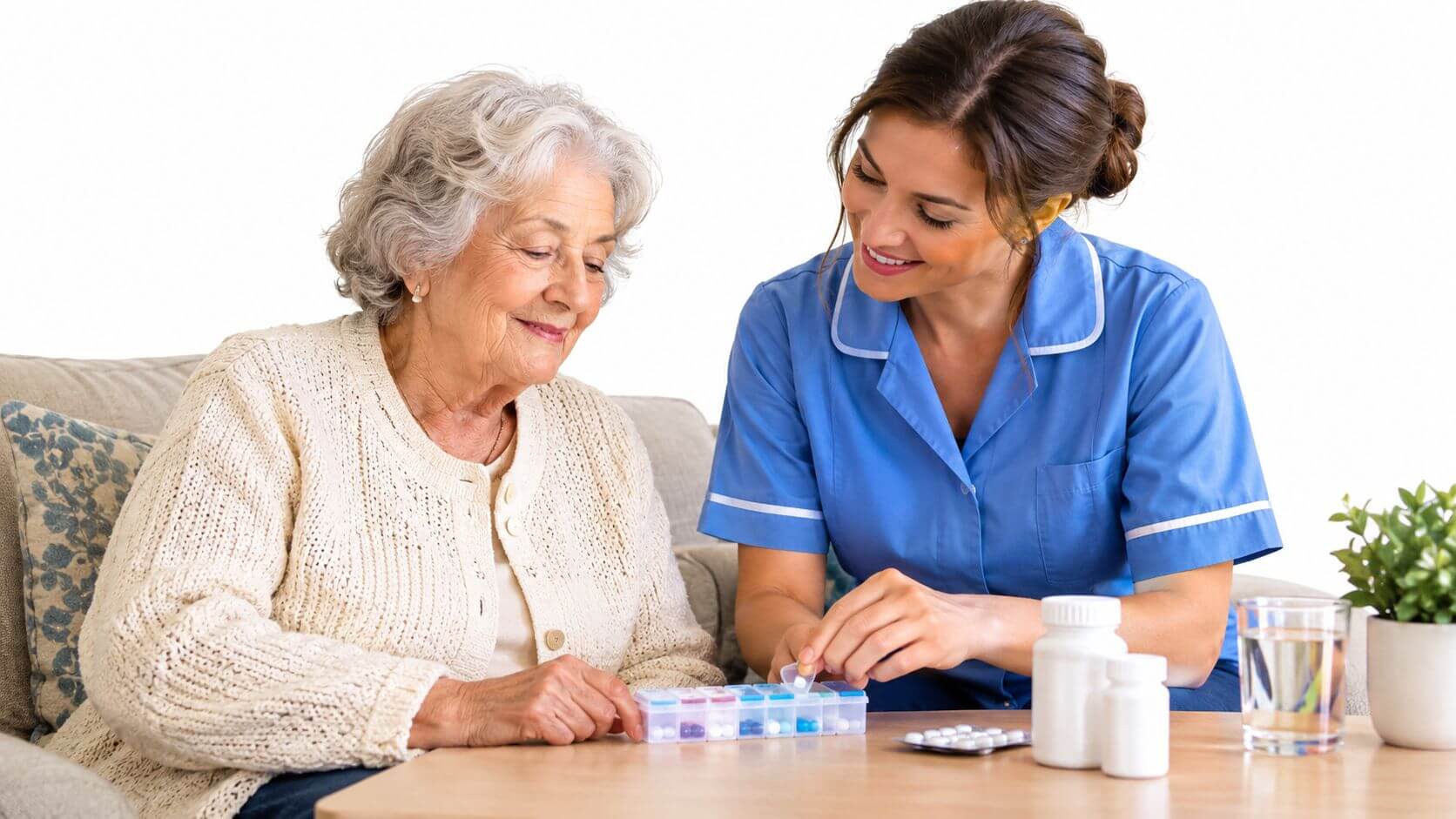 A smiling caregiver helps an elderly person organize medication in a weekly stacker.